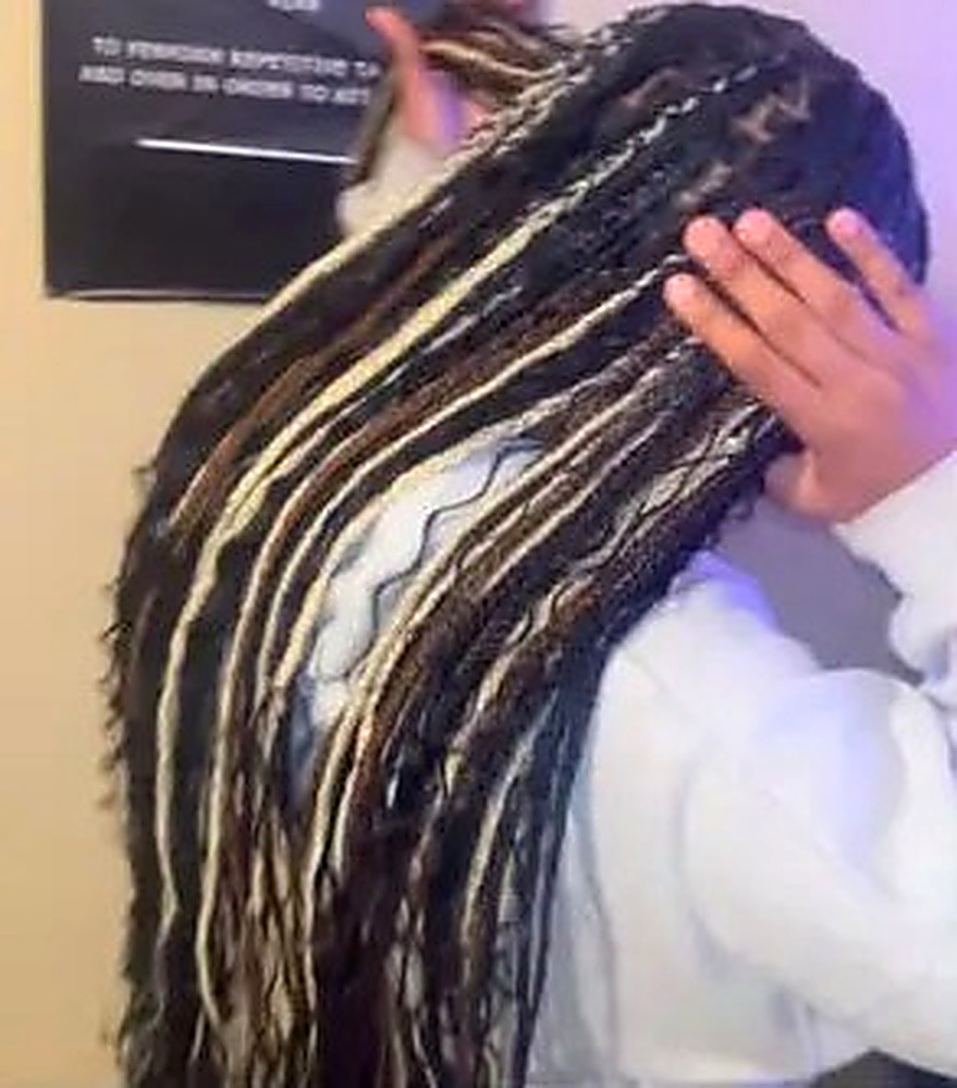 Long knotless braids with blonde highlights styled by Chass