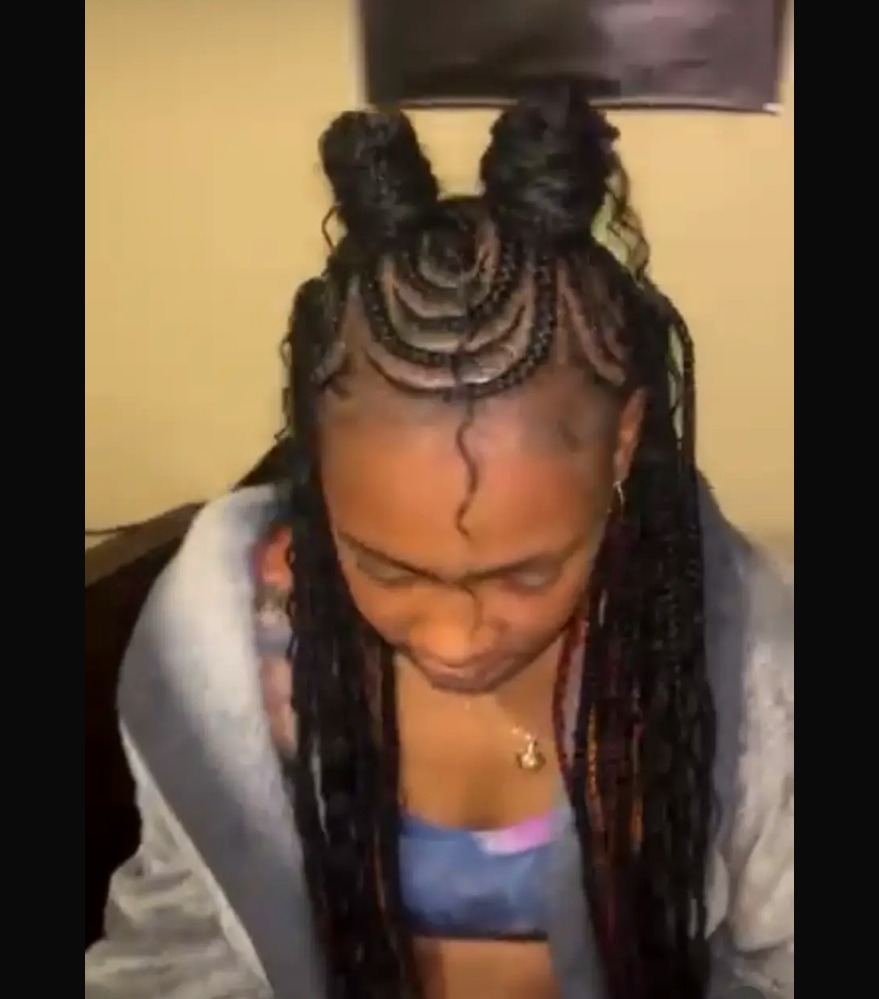 Feed-in braids styled into two braided space buns
